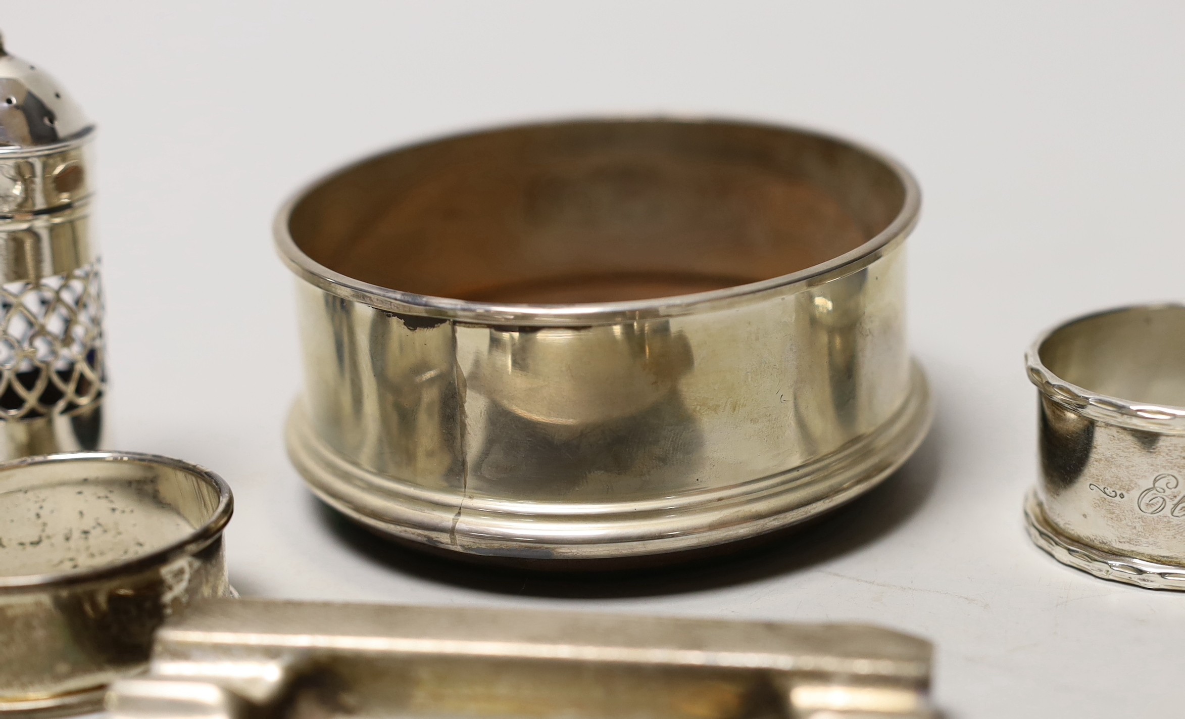 A silver coaster, ashtray, two napkin rings, cutlery etc.